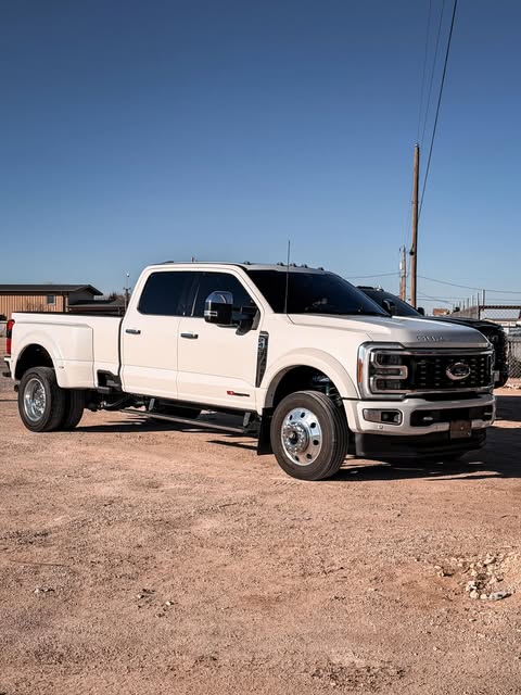 White Ford Super Duty dually photographed outside the shop